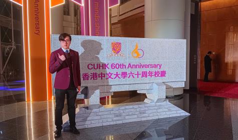 Chan Sheung Yee standing in front of sign