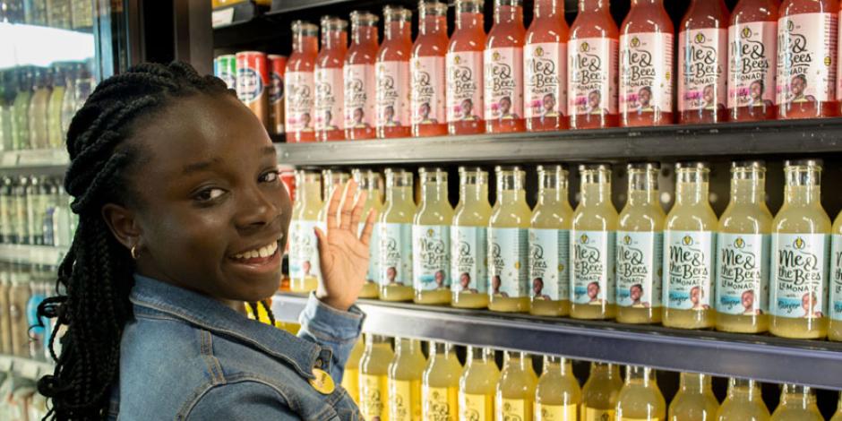 Mikaila Ulmer in front of her lemonade on a shelf in a grocery store