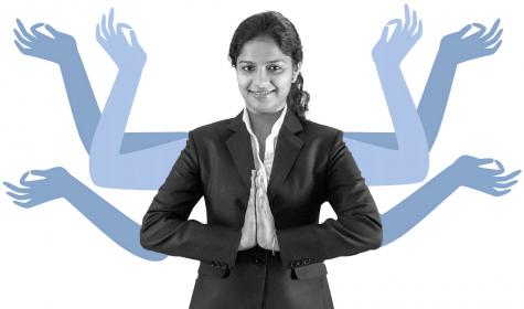 A young professional  Indian woman greeting with 'Namaste'.