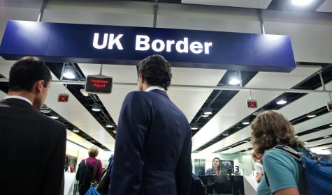 Travelers waiting at the UK border at Heathrow Airport